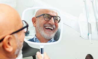 A man smiling at his new dental implants