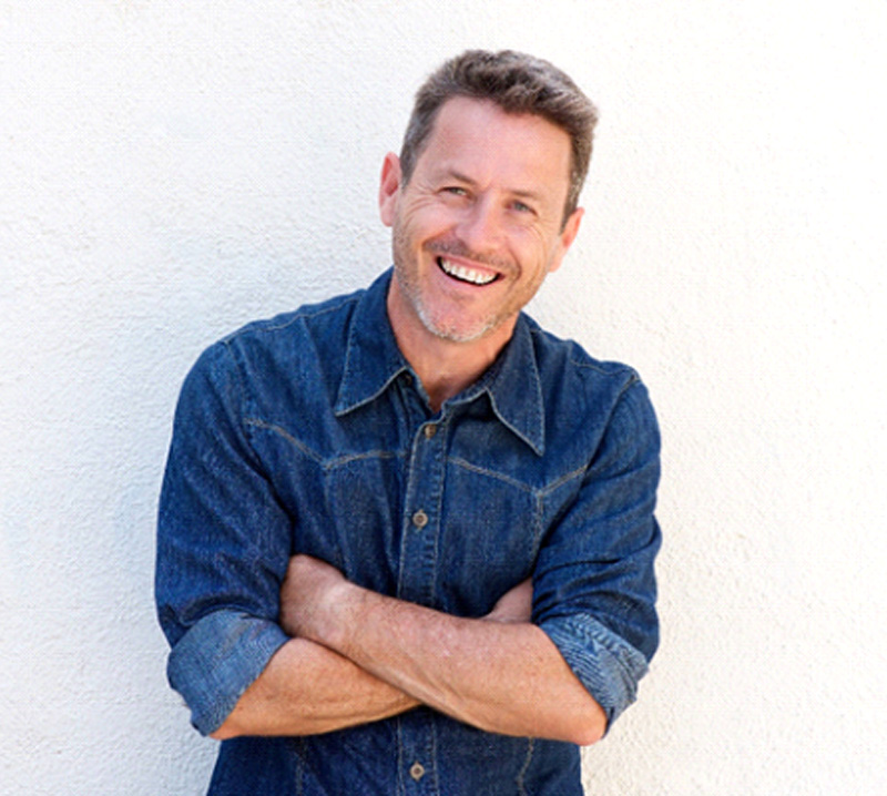 Older man with a dental bridge in Bakersfield smiling