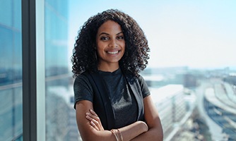 Woman in black shirt smiling in office building