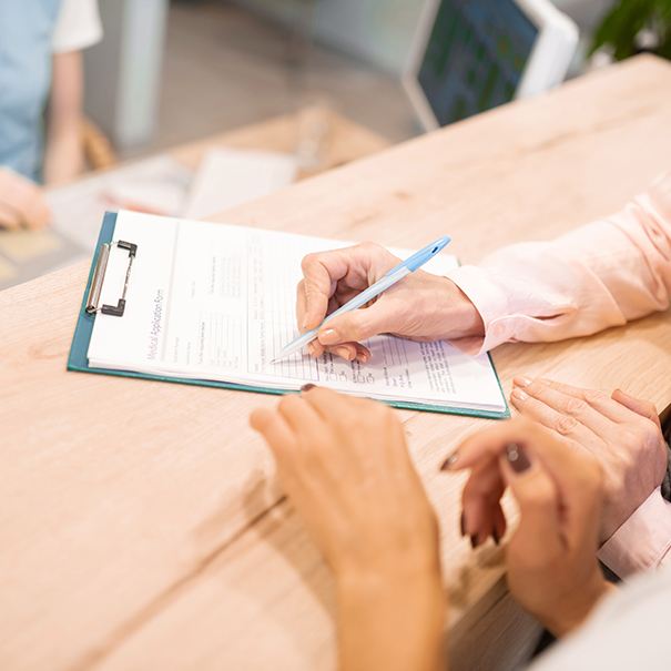 Patient filling out dental insurance forms