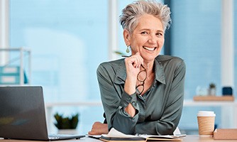 Woman at work wearing dentures in Bakersfield