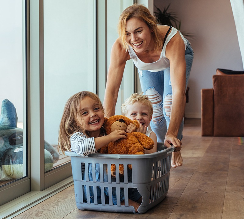 Mother and kids laughing together after family dentistry