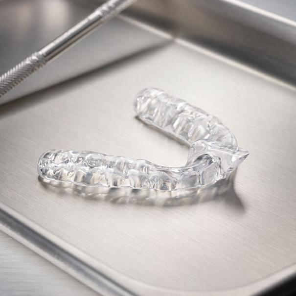 Clear nightguard for teeth grinding on metal tray