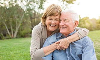 Couple smiling outside