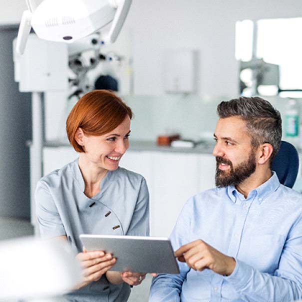 Implant dentist in Bakersfield speaking with a patient