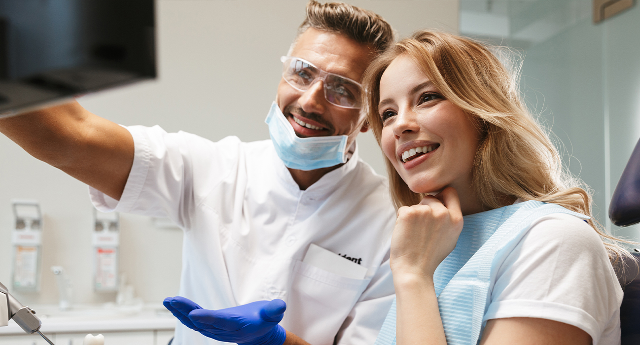 Dentist and dental patient looking at computer screen