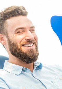 man smiling in dental mirror 