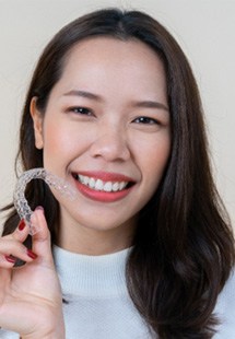 patient holding Invisalign aligner 