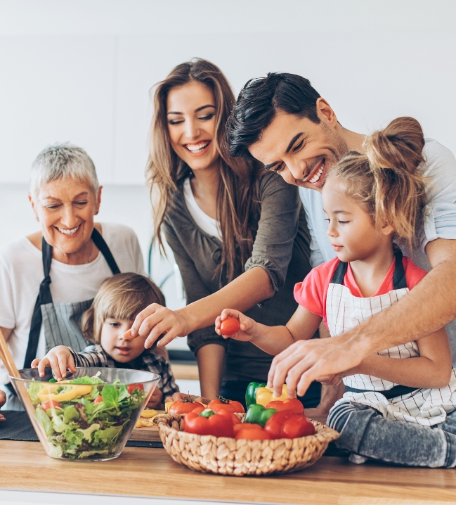 Family making dinner together after receiving dental services in Bakersfield