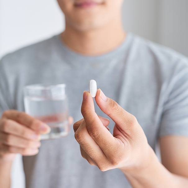 Man holding oral conscious dental sedation pill