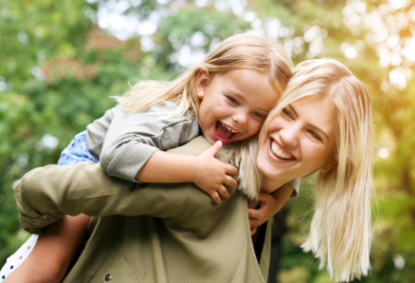 Mother and daughter smiling together after family dentistry