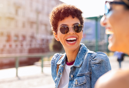 Woman with straight healthy smile after Invisalign