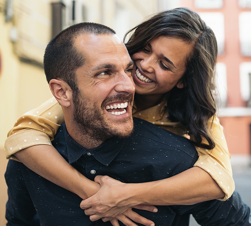 Man and woman smiling after teeth whitening