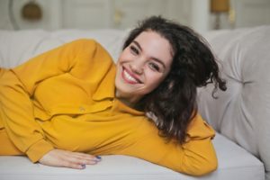 Confident woman with dental implants smiling