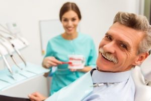 Smiling older man in dentist’s chair